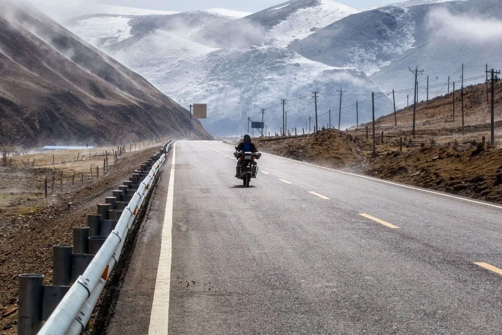 biker motorcycle road beautiful winter tibet snow mountain sichuan china
