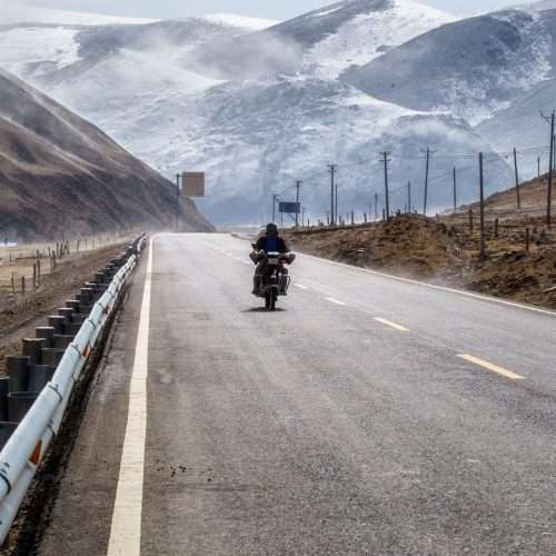 biker motorcycle road beautiful winter tibet snow mountain sichuan china