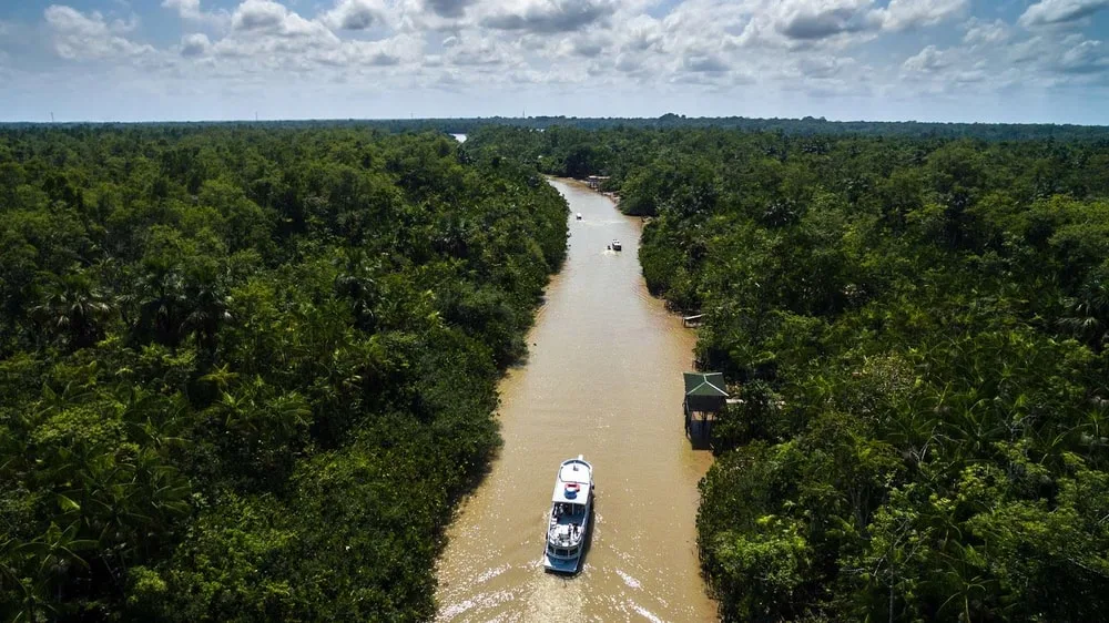 An Ariel view of a Ferry passing through the Amazon Rainforest in Brazil.
