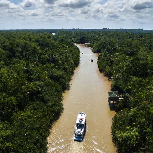 An Ariel view of a Ferry passing through the Amazon Rainforest in Brazil.
