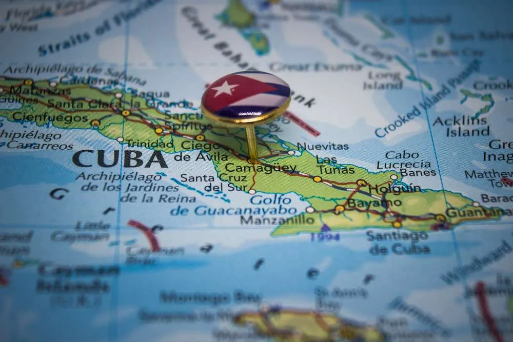 Map of Cuba with a signet ring denoting the Cuban Flag pinned in the centre
