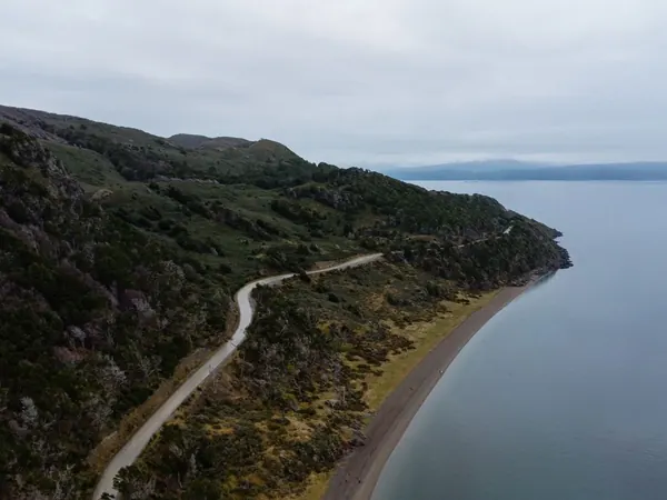 Gravel road along the water in Tierra del Fuego, near Ushuaia