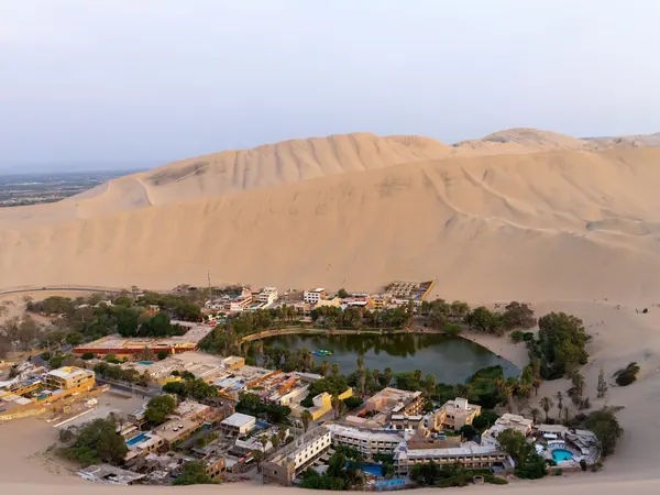 Huacachina oasis ringed by giant sand dunes