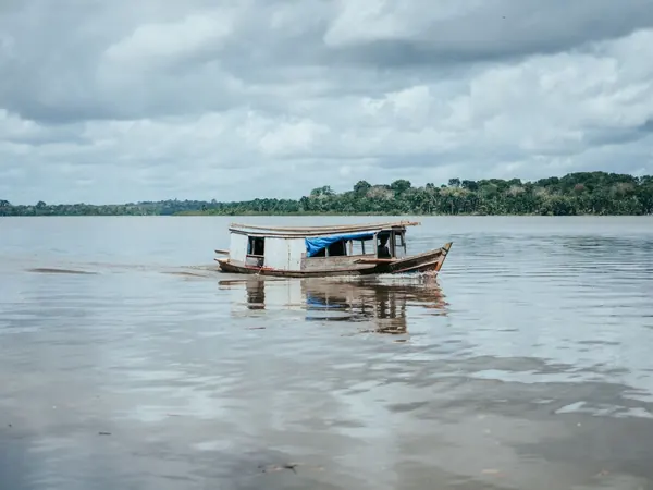 Wooden riverboat on a wide river in Parรก (Tapajรณs crossing towards the Xingu)