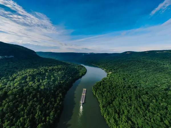 Barge on a forested river, a typical Amazon-basin scene (no free photo of the Tucuruรญ dam exists)