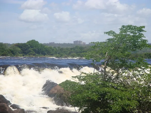 Caronรญ falls with Ciudad Guayana behind